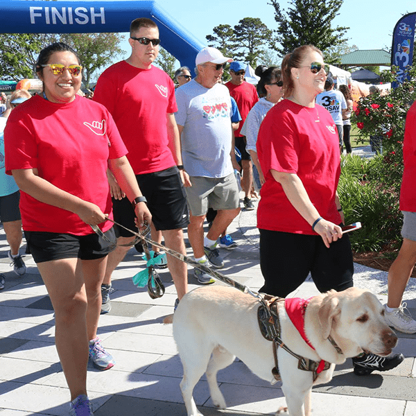 people walking at heart walk with dog