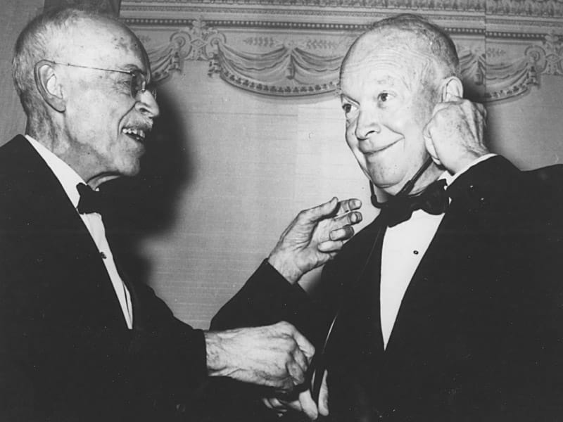 President Dwight D. Eisenhower uses a stethoscope to listen to the heart of Dr. Paul Dudley White, who had treated him for a heart attack. (American Heart Association)