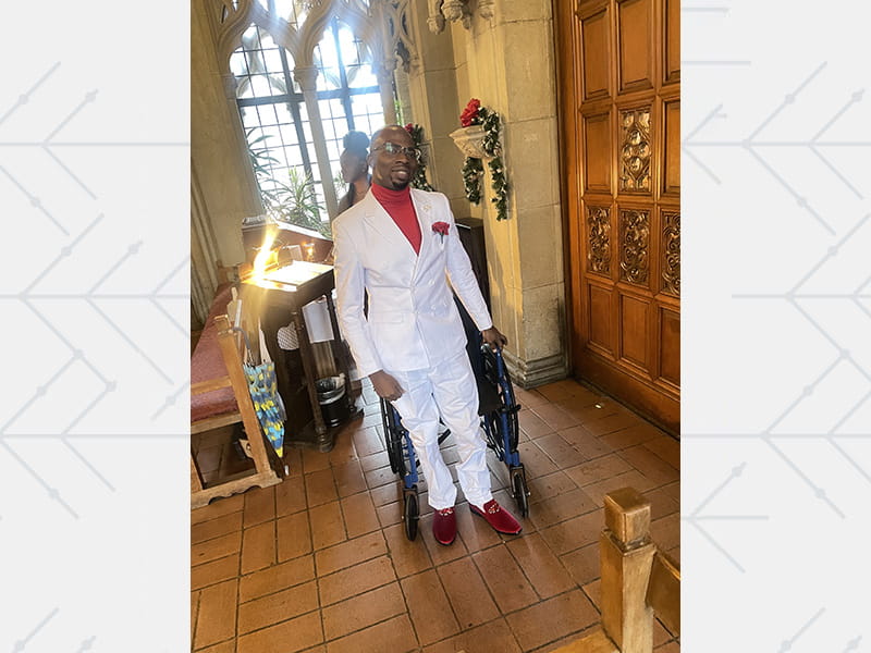 Julian Nelson wearing a white suit at church