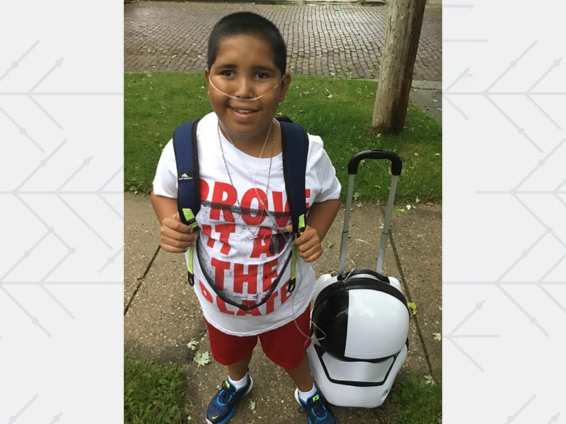 Manny Rios as a child with his "Star Wars" rolling backpack and oxygen tank