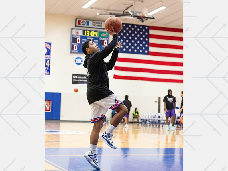Manny Rios playing basketball at Tremper High School