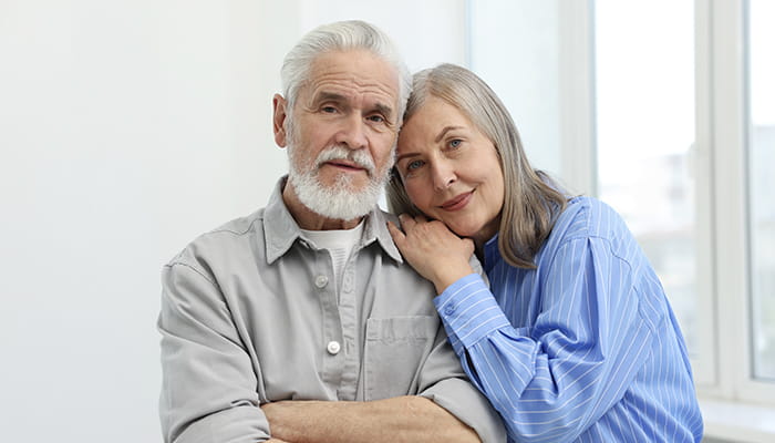 Man and woman sitting and smiling for the camera