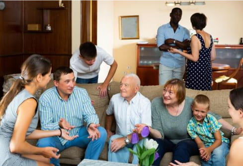 several generations of family members meeting to discuss finances in livingroom