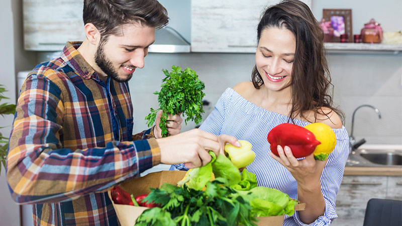 couple unloading groceries at home