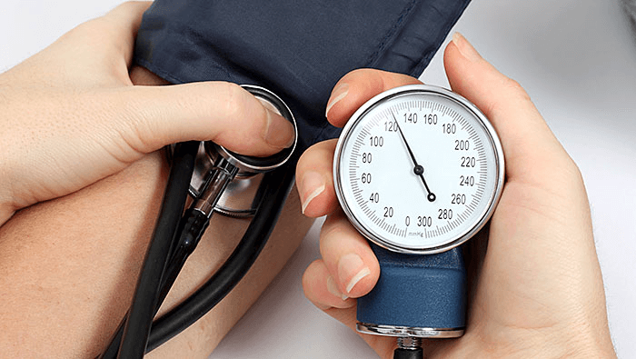 close up of hands checking someone's blood pressure