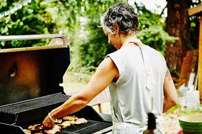 woman grilling chicken