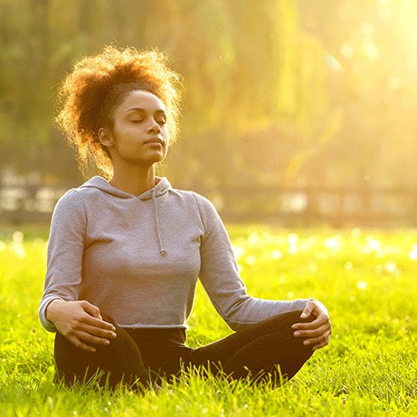 woman meditating outdoors