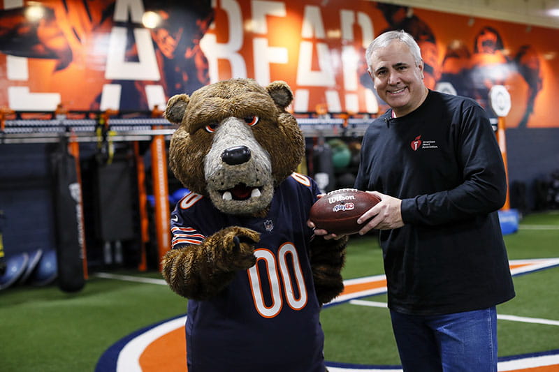 One of the most memorable days of Lloyd-Jones' tenure was filming an NFL Play 60 video with Staley Da Bear, the mascot for the NFL’s Chicago Bears. (Photo courtesy of Donald Lloyd-Jones)