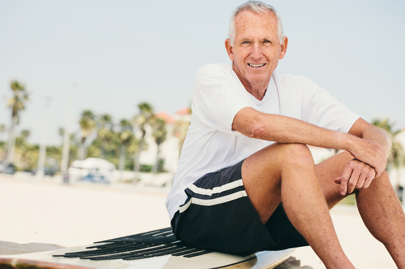 senior man on surfboard