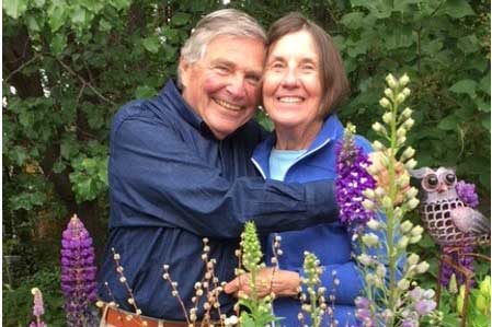 Bernie hugging a loved one in a field of flowers