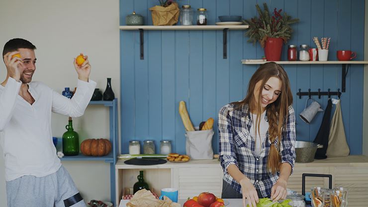 Couple preparing a meal in kitchen