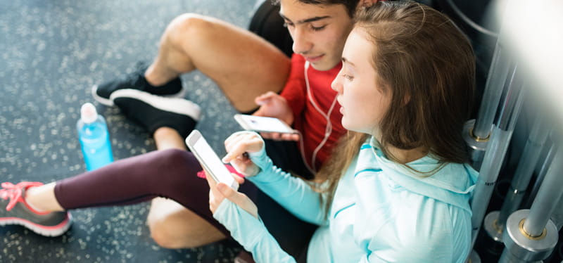 Young people looking at mobile phones.