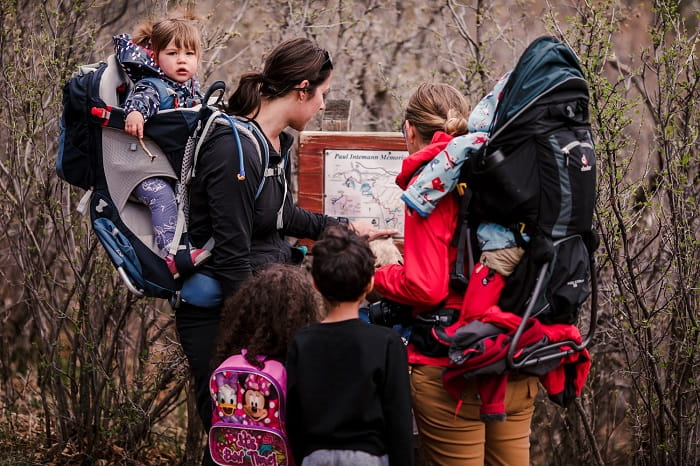 HIking families looking at educational signs. (Photo by Krystal Weir)