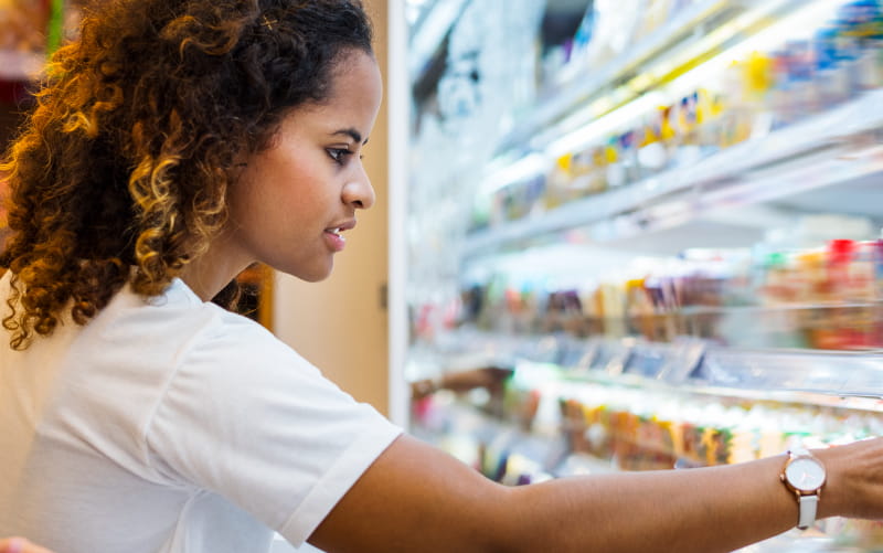 Woman looking at convenience store food.