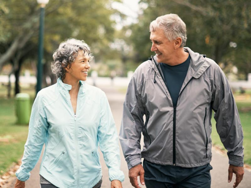 Older couple walking.