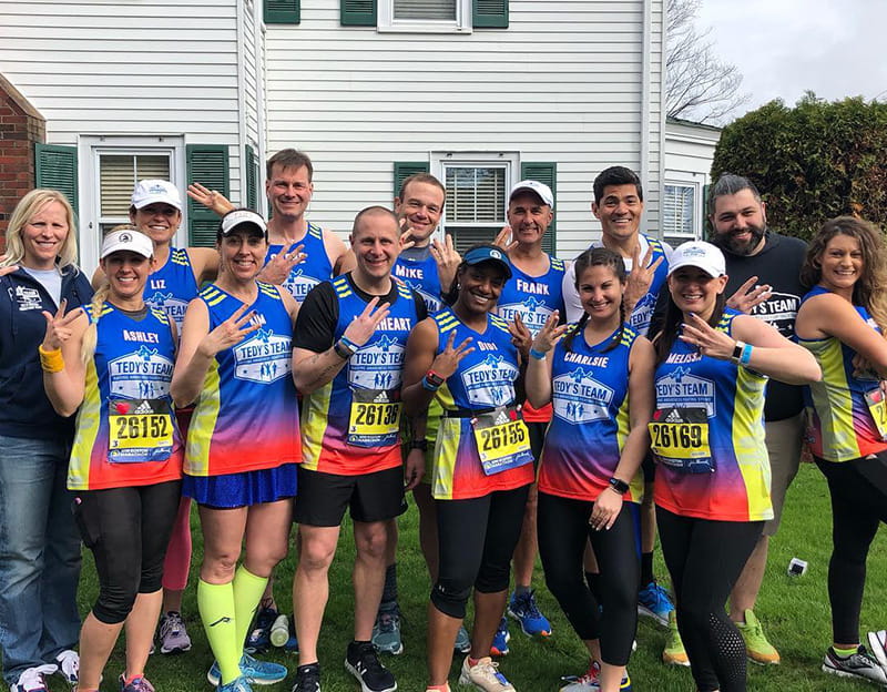 Tedy Bruschi's "Trifecta Team" poses at the Boston Marathon. (Photo courtesy of Stacy Smith Studios)