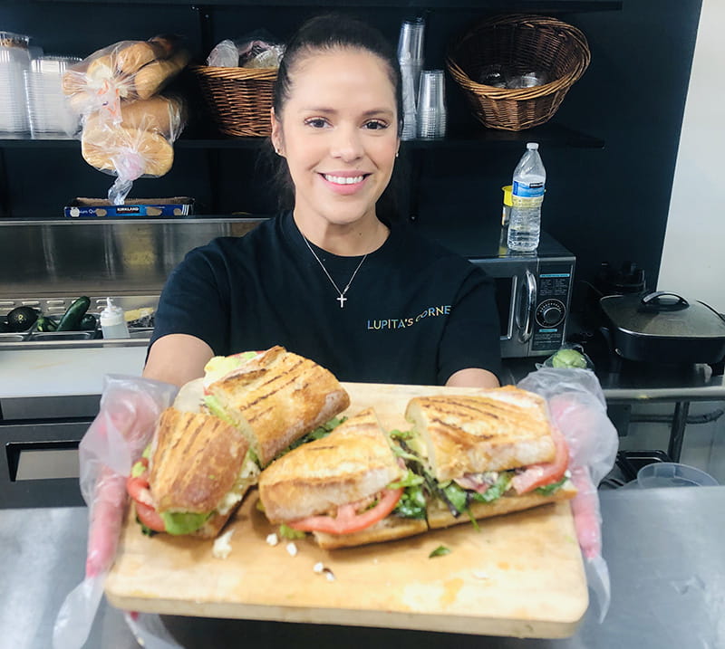 Luz Arango prepares a sandwich with fresh produce. The Healthy Neighborhood Market Network program allowed Lupita's to offer more healthy, affordable options to customers. (Photo by Marina Quiñonez-Reda)