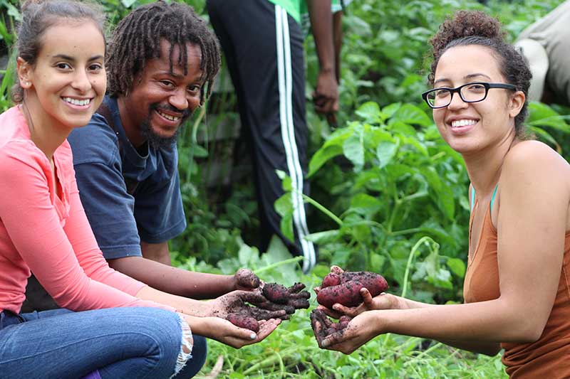 Farm Training Manager Bobby Walker (center) with trainees in 2018. (Photo courtesy of Pat Spence)