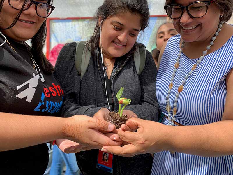 Ana Yris Guzmán with students at Nuestra Escuela. (Photo courtesy of Nuestra Escuela)