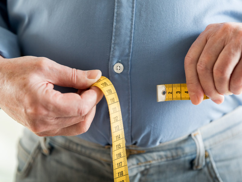 Mature Woman With Tape Measure Around Waist Mid Section High-Res Stock  Photo - Getty Images