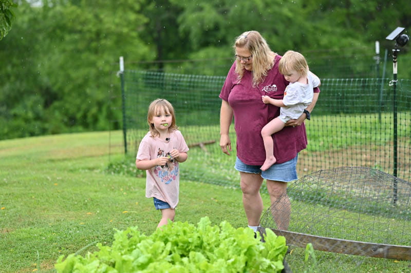 Sabrina Ford's granddaughter McKenna eats lettuce from the family's backyard garden. (Photo by Walter Johnson Jr./American Heart Association)