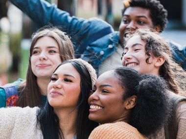 A group of smiling teenagers taking a selfie A group of smiling teenagers taking a selfie