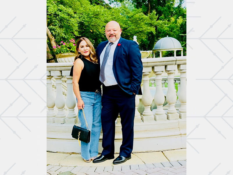Butch and Patricia Bracknell posing together outside on a balcony