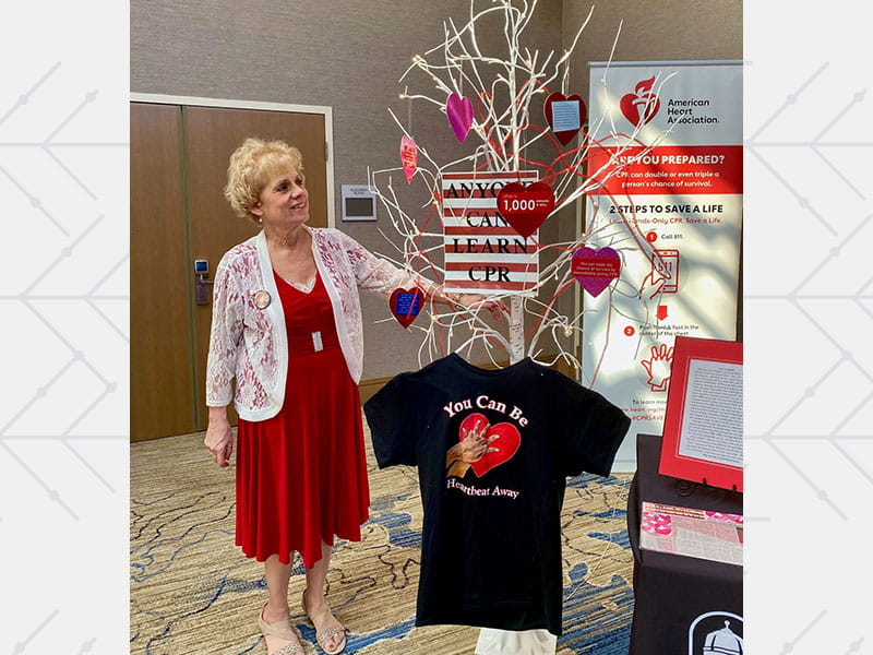 Ann holds a framed collage of the people who saved her life after her heart stopped during a church service.