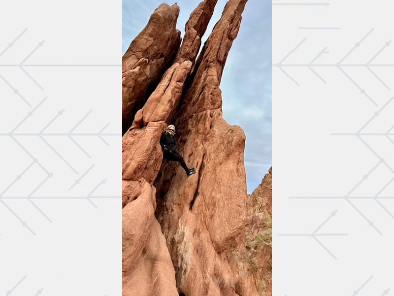 Amy climbs a rock formation at Garden of the Gods, embracing a renewed sense of purpose and a second chance at life.