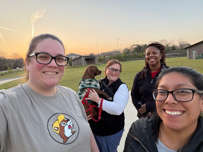 From left, Christina Gamble, Gretchen Baldvins (and her dog Charlie), Kesi Patrick and Sara Greenspan taking a stroll in Patriots Park in March in Alabaster, Alabama