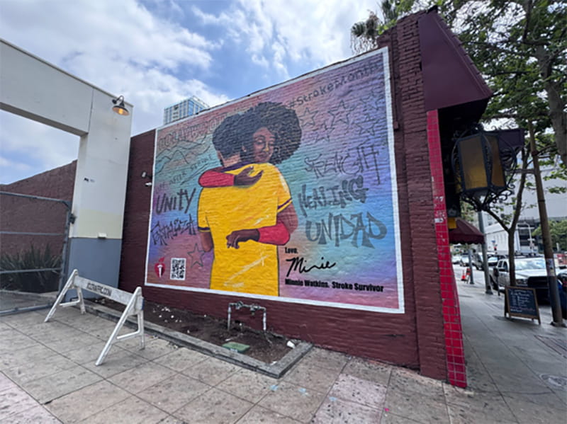 Minnie’s mural in Los Angeles includes words in English and Spanish that include “Life after stroke,” “Unity,” Strength,” and “Healing.”