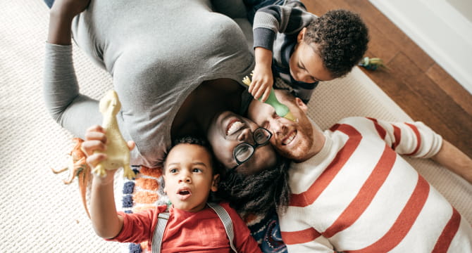 Mom and dad playing with young children