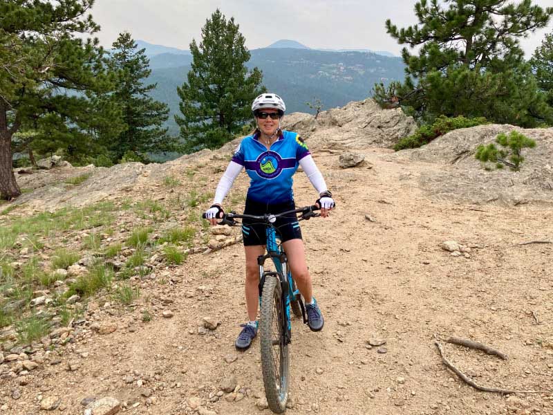 Carrie Lehtonen mountain biking in Colorado in 2021. She survived a heart attack in 2009 at age 31. (Photo courtesy of John Busch)