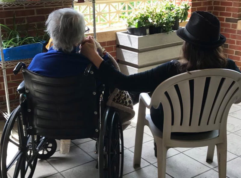 JoAnne Klimovich Harrop (right) holding Evelyn Klimovich's hand. (Photo courtesy of Carol Danhires)