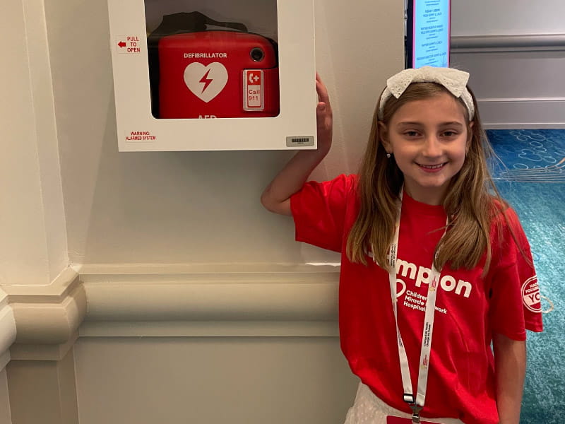 9-year-old Adeline Dinin has long QT syndrome, an electrical problem with the heart. She is known as @AED__Girl online and carries her own automated external defibrillator with her. (Photo courtesy of the Dinin family)