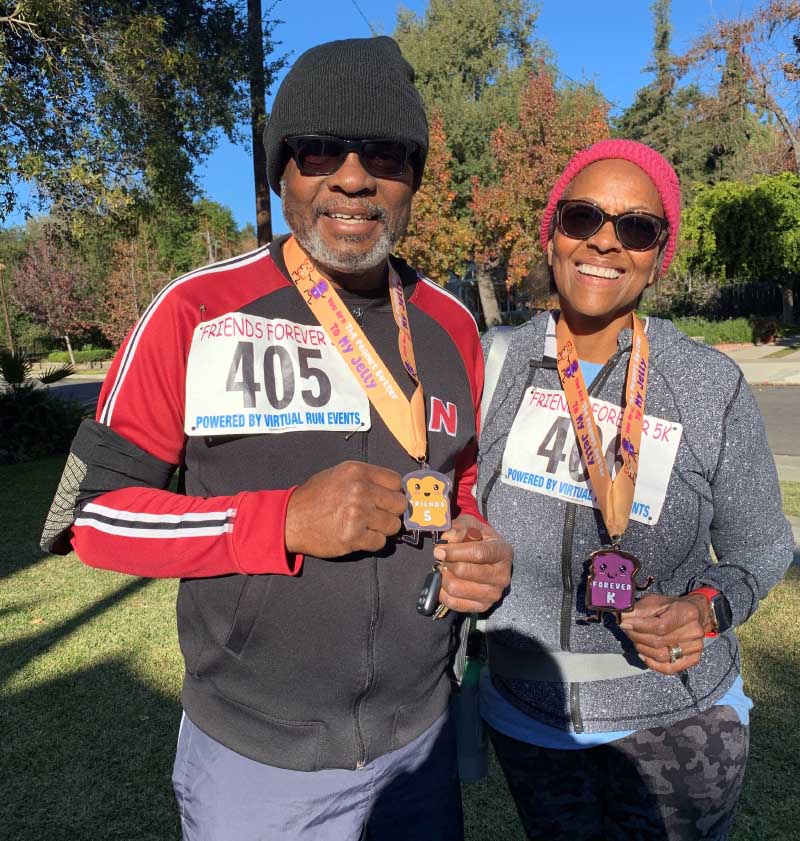 Andre and Roberta Moore earn medals for completing the 5K events their daughter, Andrea, creates for them to stay active. (Photo courtesy of the Moore family)
