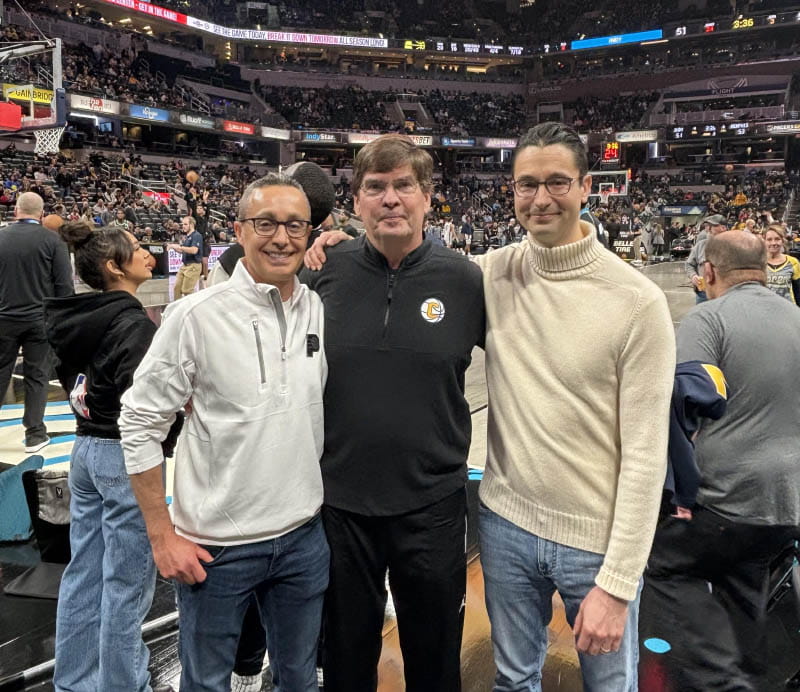 Walt Morris (center) at an NBA game with the doctors who saved his life. Dr. Felix Alva-Valdes (left) discovered Walt's aortic dissection and Dr. Giorgio Zanotti performed the 11-hour surgery. (Photo courtesy of Walt Morris)