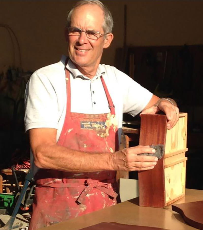 Chris Mathews refinishing a piece of furniture in his shop. (Photo courtesy of Chris Mathews)