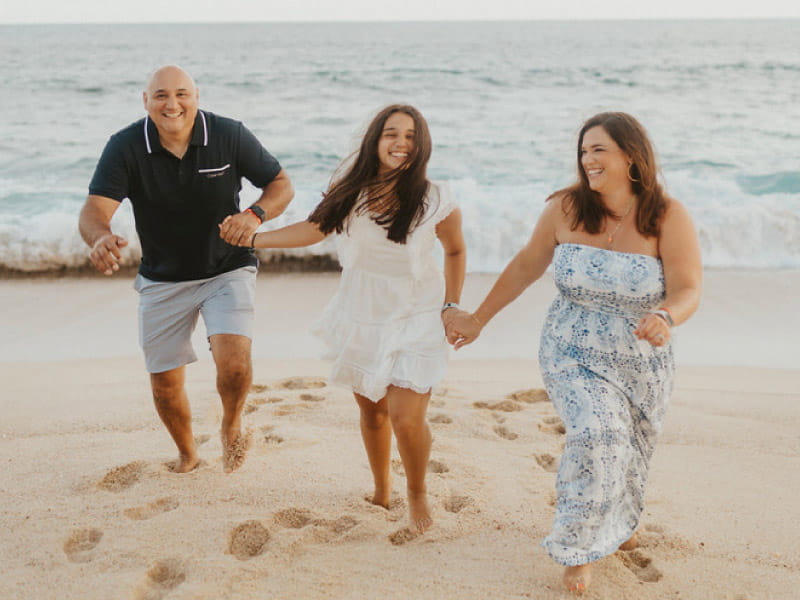 Long COVID survivor Olivia Lopez (center) with her parents, Sacramento and Laura Lopez. (Photo courtesy of Catia Lopez)