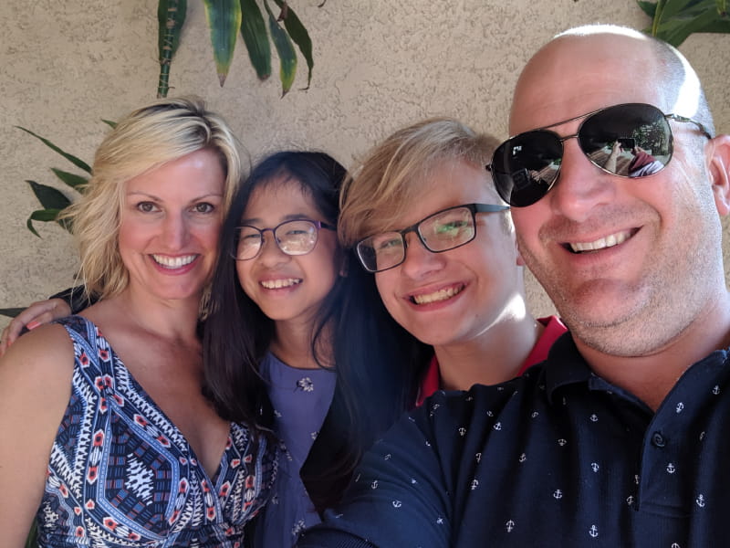 Lottie Zoog underwent a partial foot amputation and an open-heart surgery, but is still all smiles with her adoptive family. From left: Vanessa, Lottie, Noah, and Christopher Zoog.