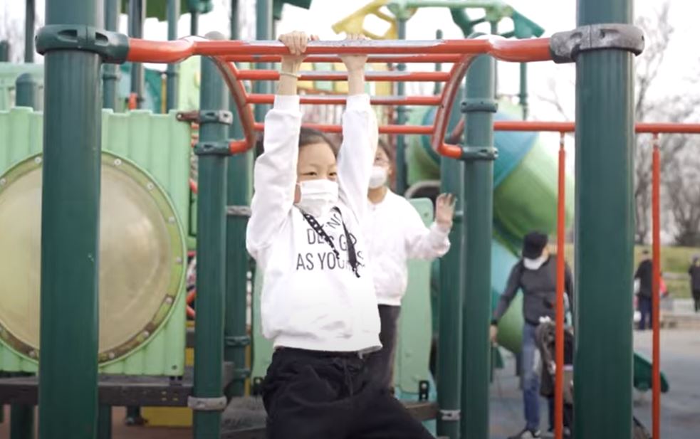 Child playing on gym bars