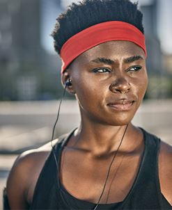 woman runner wearing headband listens to music woman runner wearing headband listens to music