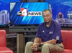 Man sitting on couch in front on ABC 4 screen