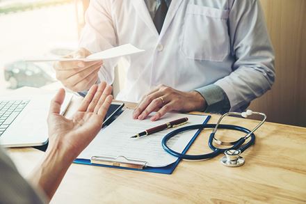 close-up-of-doctor-hands-sharing-tests with patient close-up-of-doctor-hands-sharing-tests with patient