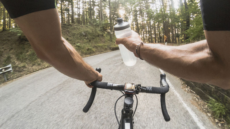 cyclist view drinking from water bottle