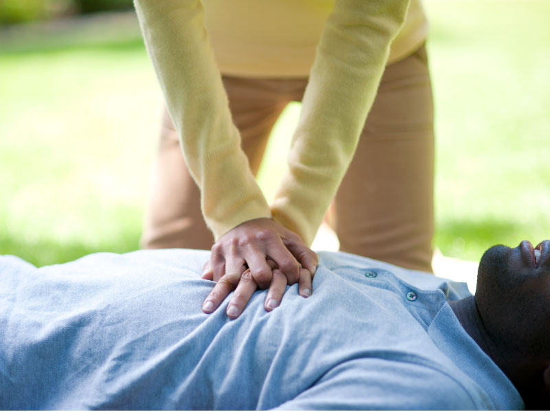 Woman giving a man CPR