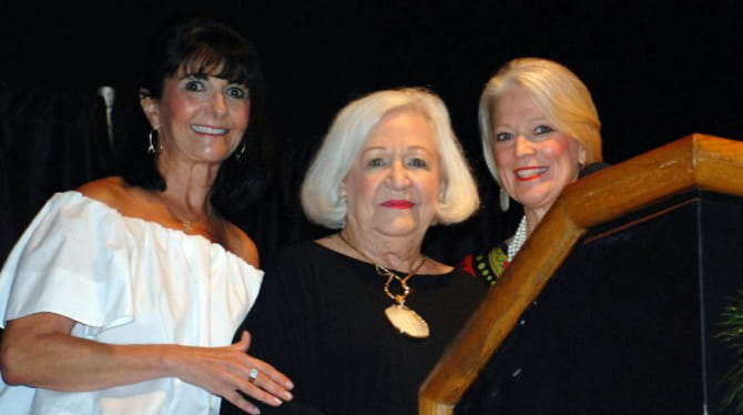 Betty Thrasher with two women at podium